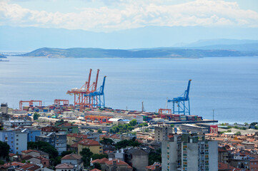 Rijeka City panorama. View of the industrial part of the city. Colorful cranes in container terminal.Mediterranean sea travel destination, marine city in europe. 