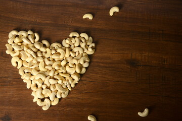 roasted salted raw cashew nuts in wooden bowl on rustic table, healthy vegetarian snack, Anacardium occidentale, Cashews on white background, Cashews nut background,Bowl with cashew nuts, cashew nuts 