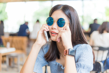 Business women use smartphone in coffee shop