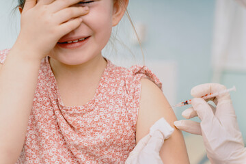 Doctor vaccinating little child in modern clinic. High quality photo