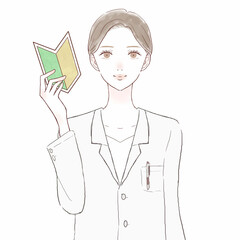 初心者マークを持っている女性医師