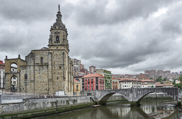 Fototapeta na wymiar Church and stone bridge next to the Bilbao estuary