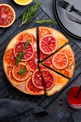 Blood orange upside down cake or pie on a blue background. Fruit citrus baking. Top view