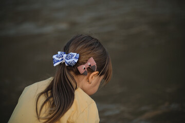Beautiful hairstyle of child is little side view from behind. Hairstyle of Caucasian little girl...