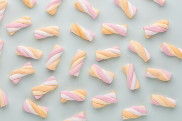 Colorful marshmallows on pastel background.