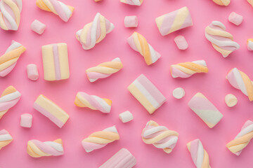 Colorful marshmallows on pastel background.