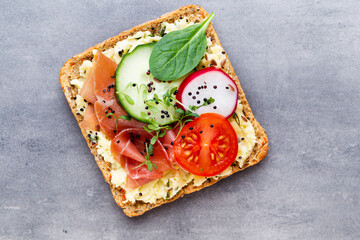 Sandwiches with cream cheese, vegetables and salami.