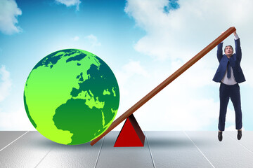 Businessman lifting the earth in challenge concept