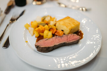 Delicious tenderloin and vegetables on a plate at a restaurant