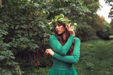 Young woman in green dress in the park