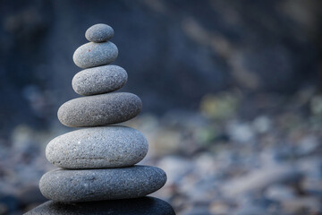 Stone piles made along a beach and the sea in the background. High quality photo