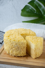 Double Fromage cheesecake on wood board
