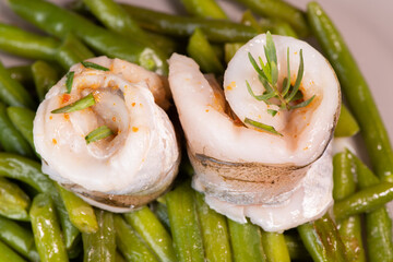 Recipe for steamed whiting fillets with tarragon, green beans and espelette pepper. High quality photo