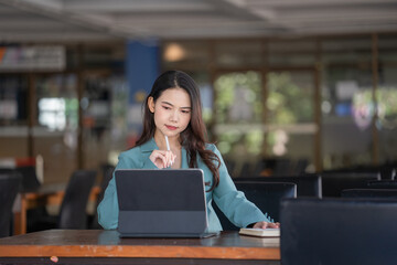 Portrait of a businesswoman working and thinking in the office.