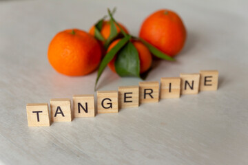 tangerines with wooden block letters