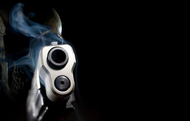 Smoking ghost gun pistol 3D rendering with a skull behind on a black background