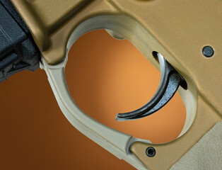 Assault rifle trigger on brown