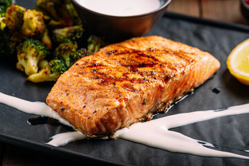 Gourmet grilled salmon fillet with broccoli and sauce