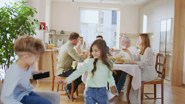 Multiracial senior man having dinner together with his family at home indoor. Relationships and holidays concept