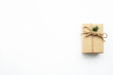 Brown gift box with festive decoration for Christmas and new year is on white background. Top view with copy space, flat lay.