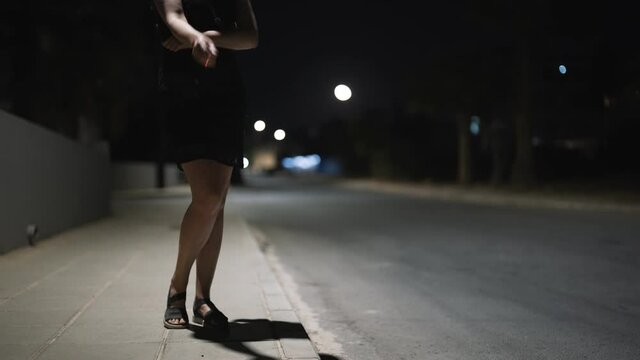 Female prostitute with cigarette on the street.
