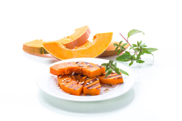 sweet baked grilled pumpkin with seeds in a plate