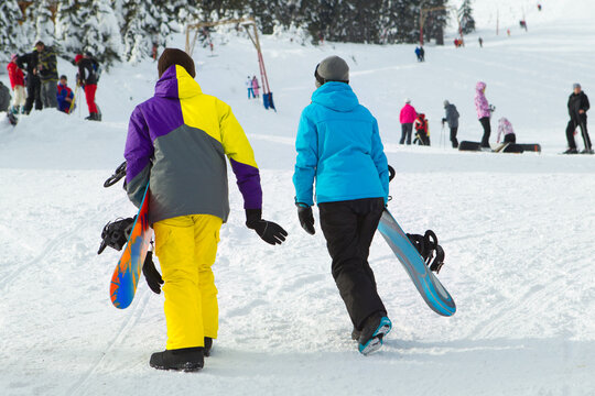 Portrait Of Couple Of Snowboarders Outside During Winter Vacations