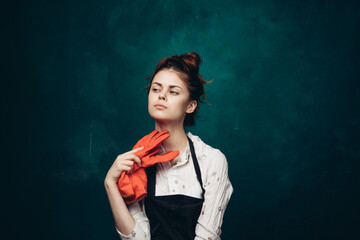 woman with rubber gloves in apron cleaning housework