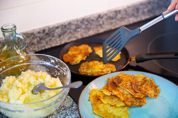 Frying of potato pancakes. European cuisine traditions. Home cooking process