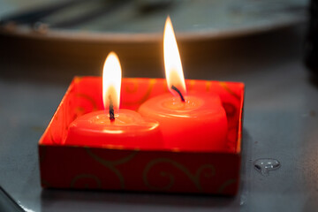 Two red wedding candles in the shape of a heart. Close-up.
