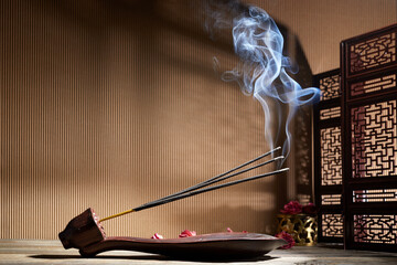 Smoke from burning incense sticks standing on lotus incense holder - obrazy, fototapety, plakaty