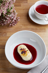 cottage cheese pancakes with berry sauce on wooden table close up. morning table. breakfast concept.