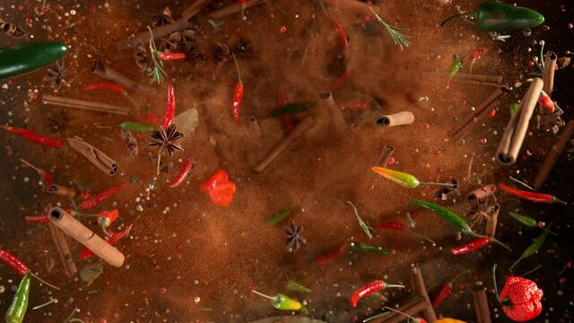 Super slow motion of flying spices mix on black background. Speed ramp effect. Filmed on high speed cinema camera, 1000 fps