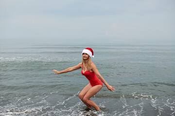 beautiful girl in a red swimsuit on the sea beach