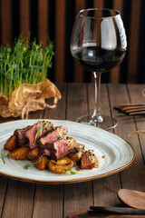 Gourmet beef medallions dish with potatoes and mushrooms