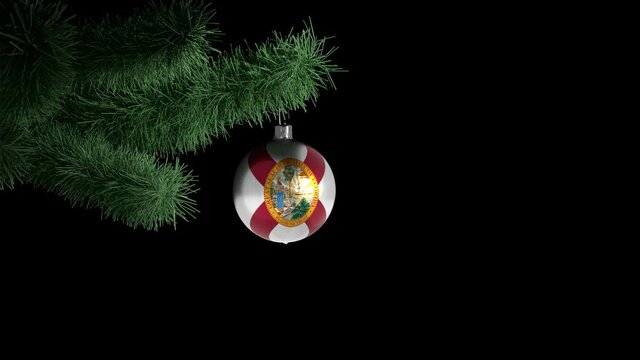 New Year's ball with the flag of Florida, USA on a Christmas tree branch in looped animation on a transparent background (alfa chanel). Christmas and New Year concept.