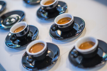 Cups of coffee in the hands of men and women. coffee break on a wooden background. with copy space. top view