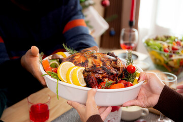 Happy family with hands of mother served roasted turkey on Christmas holiday at home, thanksgiving eve, woman preparing food for celebrating and dinner with family, festive xmas and new year.