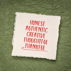 honest, authentic, creative, thoughtful and thankful - positive words or character traits - handwriting on a small square sheet of handmade paper, positive affirmations or personal development concept