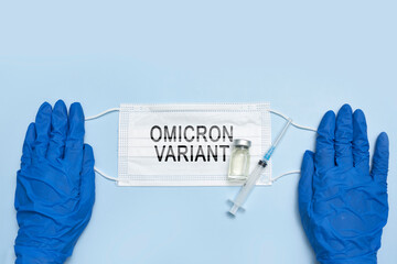 Female doctor holds a face mask with - Omicron variant text on it. Covid-19 new variant - Omicron....
