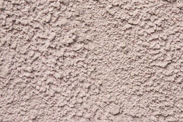 Old pink wall with peeling plaster, grunge background