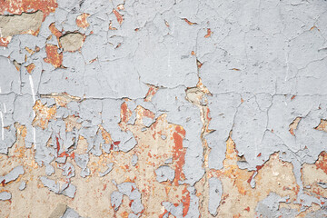 Old colored bright wall with peeling plaster, grunge background