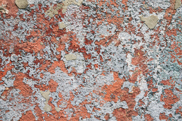 Old colored bright wall with peeling plaster, grunge background