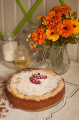 a homemade round sweet pie with berries is on the table in vertical format