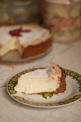 a piece of homemade sweet cake with berries is on a plate in vertical format