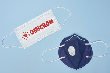 Female doctor holds a face mask with - Omicron variant text on it. Covid-19 new variant - Omicron....
