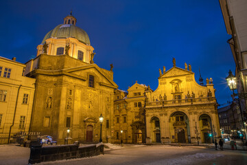 Fototapeta na wymiar Prague - evening on the snowy Cross Square near Charles Bridge