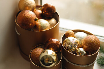 The decorative brown balls in the gold boxes on a window