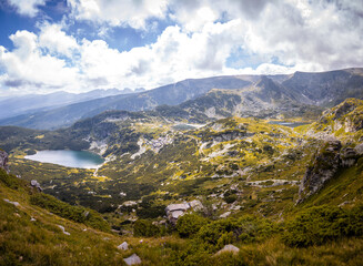 Fototapeta premium Beautiful landscape of the Seven Rila Lakes,Bulgaria. Amazing nature shot, mountains and lake.Reflecting water on sunny cloudy day. High quality photo