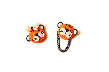Handmade knitted soft toy. Two littlestripes tiger on the white background. Crochet and knitting stuffed animals.